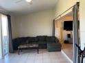 Cozy living room features tile flooring and sliding glass doors for natural light at 206 Orchid Dr, Davenport, FL 33897