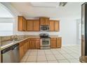 Kitchen with stainless steel appliances, granite countertops, and ample cabinet space at 236 Savannah Preserve Loop, Davenport, FL 33837