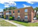 A charming brick condo with a second-floor balcony and beautiful landscaping at 2423 Branch Way # 207, Maitland, FL 32751