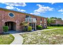 Brick condo with a balcony, screened porch, a distinctive round window, and attractive landscaping at 2423 Branch Way # 207, Maitland, FL 32751
