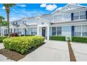Desirable light blue townhome with charming curb appeal and well-maintained landscaping at 2530 Maneshaw Ln, Kissimmee, FL 34747