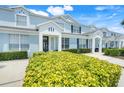 Inviting townhouse complex with light blue exterior, well-kept landscaping and private entrances at 2530 Maneshaw Ln, Kissimmee, FL 34747