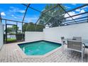 Relaxing screened-in pool area with tile flooring, outdoor seating and views at 2530 Maneshaw Ln, Kissimmee, FL 34747