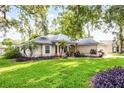 Inviting single-Gathering home with mature, colorful landscaping and a well-maintained lawn creating beautiful curb appeal at 2711 Bayview Dr, Eustis, FL 32726