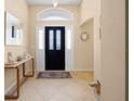 A welcoming foyer with neutral tones, decorated with console table and stylish decor at 3008 Bridgefield Ct, The Villages, FL 32162