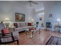 Cozy living room with hardwood floors, ceiling fan, and comfortable seating at 3112 Burbank Ln, The Villages, FL 32162