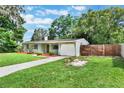 A charming single-story home with an attached garage, and a partial fence at 315 W 11Th Ave, Mount Dora, FL 32757