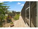 Backyard with a screened lanai and a lush lawn at 3411 Eisenhower Way, The Villages, FL 32163
