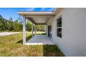 The covered patio offers a shady spot with space for outdoor relaxation at 40685 E Ninth Ave, Umatilla, FL 32784
