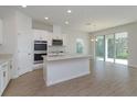 A kitchen featuring an island, stainless steel appliances and an open floorplan at 5009 Balsam Falls Rd, Deland, FL 32724