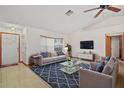 Bright living room with tile and carpet flooring, fan, and large window providing ample light at 501 Cherry Tree St, Eustis, FL 32726