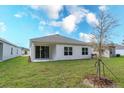 Spacious backyard with sliding glass doors leading to the covered patio, perfect for outdoor entertaining at 5025 Balsam Falls Rd, Deland, FL 32724
