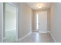 Bright entryway features neutral paint, tiled flooring, and a door with window panels at 5036 Balsam Falls Rd, Deland, FL 32724