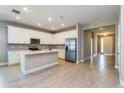 Bright kitchen boasts white cabinets, stainless steel appliances, and a center island at 5036 Balsam Falls Rd, Deland, FL 32724