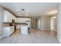 Open kitchen featuring white cabinets, stainless appliances, and wood-look flooring at 5036 Balsam Falls Rd, Deland, FL 32724