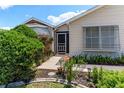 Well-manicured lawn and mature landscaping create a welcoming entrance to this home at 735 Palma Dr, The Villages, FL 32159