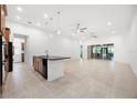 Open-concept kitchen with large island, tile floors, and stainless-steel appliances at 780 Mystic Hill Ct, Kissimmee, FL 34759