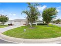 Well-maintained home with lush green lawn and mature trees in a serene neighborhood setting at 8608 Se 141St Street Rd, Summerfield, FL 34491