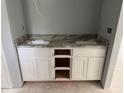 Bathroom vanity with double sinks and granite countertop, plus storage at 919 Cr 482C, Lake Panasoffkee, FL 33538