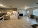Open concept kitchen featuring stainless steel appliances, and ample cabinet space for storage solutions at 102 Harold St, Leesburg, FL 34748