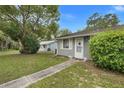 Quaint home with a well-maintained lawn, pathway to the door, and lush greenery around the house at 10301 Us Highway 27 # 187, Clermont, FL 34711