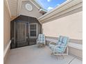 Relaxing screened patio featuring comfortable seating and neutral tones at 10986 Se 171St Street Rd, Summerfield, FL 34491