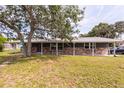 Charming single-story home featuring a brick facade, covered porch, and well-maintained front lawn at 110 River Beach Dr, Ormond Beach, FL 32176