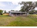 Inviting single-level home with brick details, carport, tidy landscaping, and cozy covered porch at 110 River Beach Dr, Ormond Beach, FL 32176