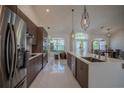 Modern kitchen with stainless steel appliances, sleek cabinets, and a center island at 11036 Bronson Rd, Clermont, FL 34711
