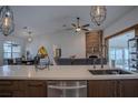 Open-concept kitchen with stainless steel appliances and an island leading into the living area at 11036 Bronson Rd, Clermont, FL 34711