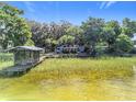 Aerial view of waterfront home with private dock and boat house, showcasing the lakefront property at 1107 Northshore Dr, Eustis, FL 32726