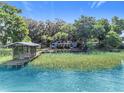 Lakefront home boasts a private dock with a gazebo and lush green surroundings offering serene waterfront living at 1107 Northshore Dr, Eustis, FL 32726