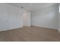 An airy bedroom features light-colored wood floors, crisp white walls, and a double-door closet at 14249 Crest Palm Ave, Windermere, FL 34786