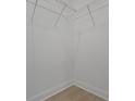 A well-lit walk-in closet includes wire shelving and light wood flooring, perfect for organized storage at 14249 Crest Palm Ave, Windermere, FL 34786