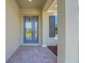 Welcoming front porch with gray stucco siding and a blue front door at 14285 Crest Palm Ave, Windermere, FL 34786