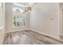 Formal dining room featuring luxury vinyl flooring, coffered ceiling, and plantation shutters at 16951 Florence View Dr, Montverde, FL 34756