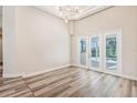 Spacious living room with high ceilings, vinyl flooring, and sliding glass doors to the lanai at 16951 Florence View Dr, Montverde, FL 34756