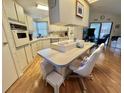 Bright kitchen with a large island, modern appliances, and ample cabinet space at 175 Hibiscus Way, Leesburg, FL 34748