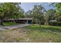 Landscaped front yard and driveway leading up to this home at 18015 Palm St, Umatilla, FL 32784