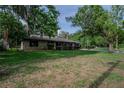 Charming single-story brick home with lush landscaping and mature trees at 18015 Palm St, Umatilla, FL 32784