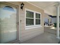 Close-up of home entrance featuring modern door, window, and carport at 1805 Jefferson Dr, Mount Dora, FL 32757