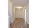 Inviting foyer with neutral decor and wood-look tile flooring at 2364 Juniper Berry Dr, Minneola, FL 34715