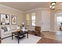 Bright living room featuring neutral walls, modern lighting, and stylish decor at 245 Blue Cypress Dr, Groveland, FL 34736