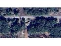 Aerial view of property showing roof and surrounding trees and proximity to Sailboat Drive at 24892 Sw Sailboat Dr, Dunnellon, FL 34431
