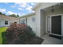 Close-up of the front entrance featuring a well-kept lawn and tasteful landscaping at 25406 Crestwater Dr, Leesburg, FL 34748
