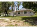 Side view of a single story home with a well-maintained lawn and mature trees at 2701 S Dellwood Dr, Eustis, FL 32726