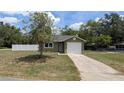 Charming single-story home with a well-maintained lawn and an attached one-car garage at 2718 Lorraine Dr, Leesburg, FL 34748