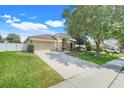 Well maintained single-story home with a concrete driveway and mature landscaping at 2889 Columbus Ave, Clermont, FL 34715