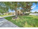Beautiful single-story home with a large tree with a swing hanging from it in the front yard at 2889 Columbus Ave, Clermont, FL 34715