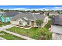 Cream-colored single Gathering home with a well-manicured lawn and easy to maintain landscape at 2896 Picadilly Cir, Kissimmee, FL 34747